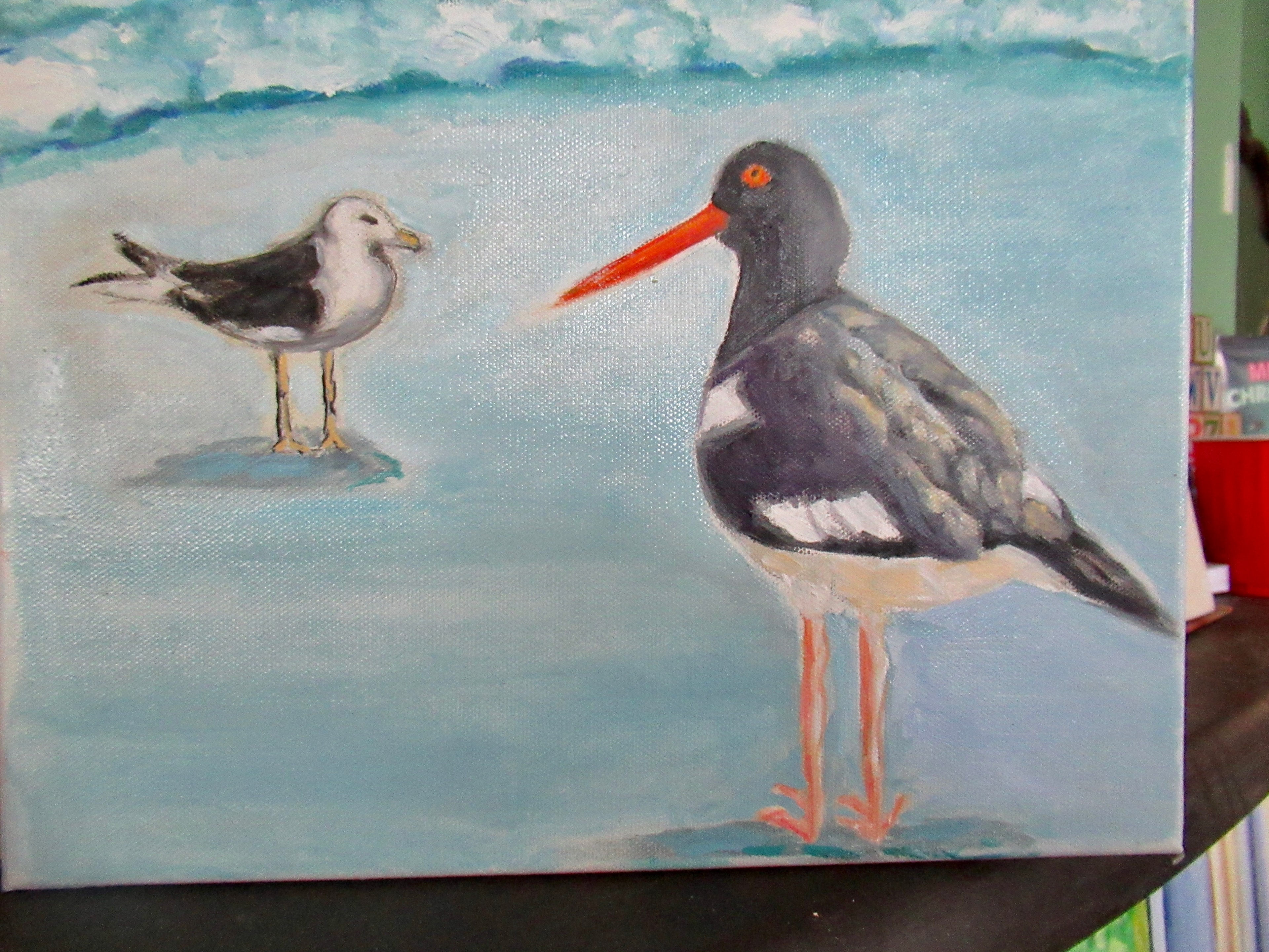 Oystercatcher and seagull standing on beach with ocean waves — original artwork by Lisa